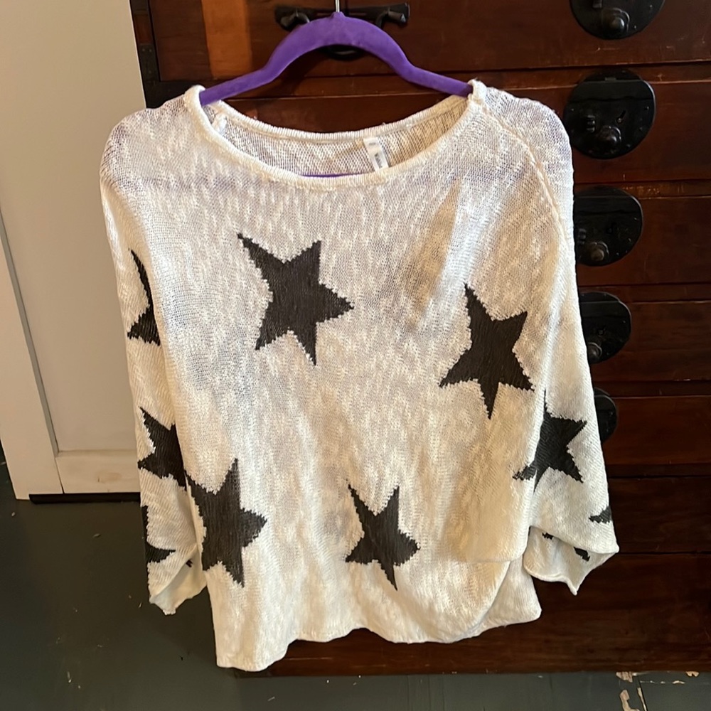 White knit sweater with black stars